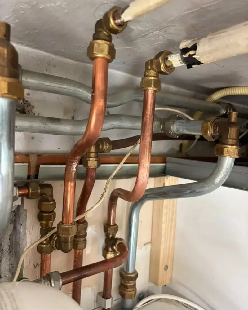 Copper pipework with couplings above an installation